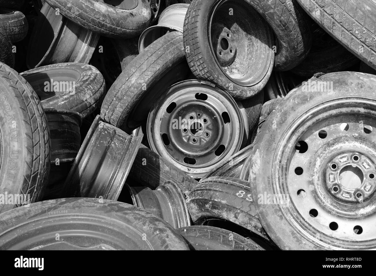 Randomly placed used or discarded tires with rims or wheels; Austin, Texas, USA. Stock Photo
