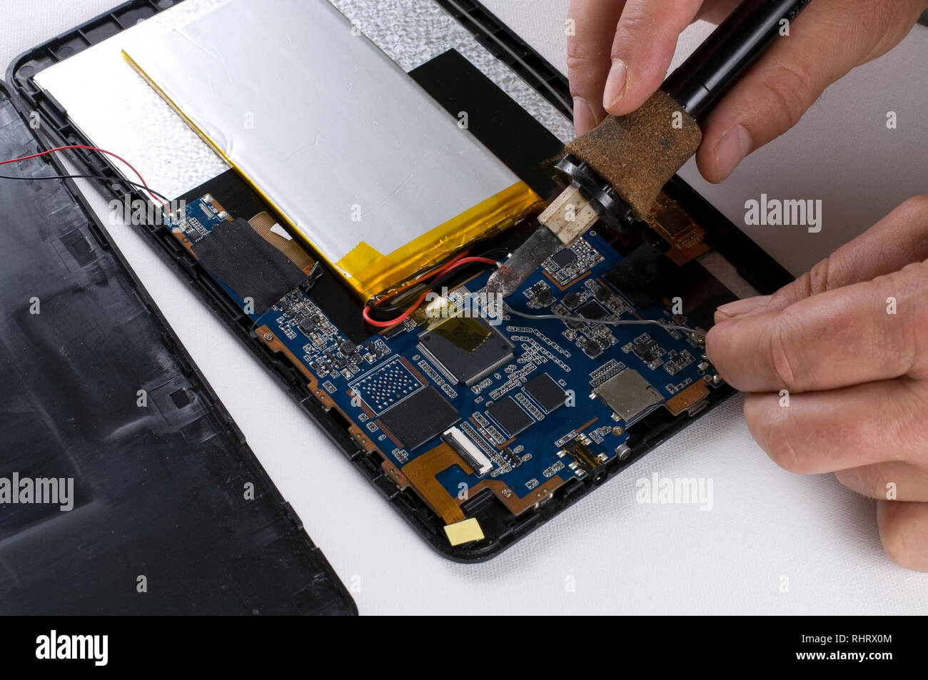 Repairman Soldering Electronic Device on White Background Stock Photo