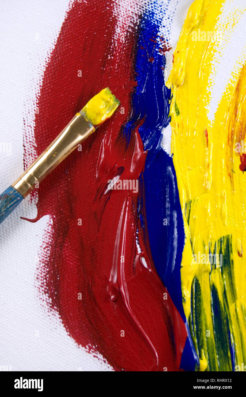 Beautiful Red, Blue and Yellow Paint and Brushes on White Canvas Stock ...