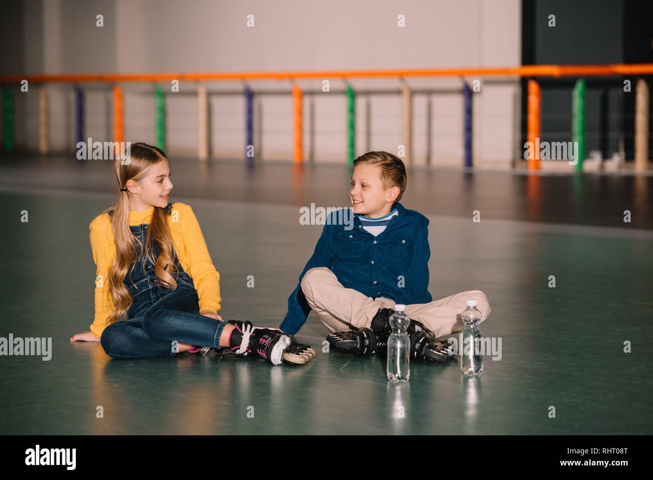 Cute kids resting after skating with roller skates Stock Photo