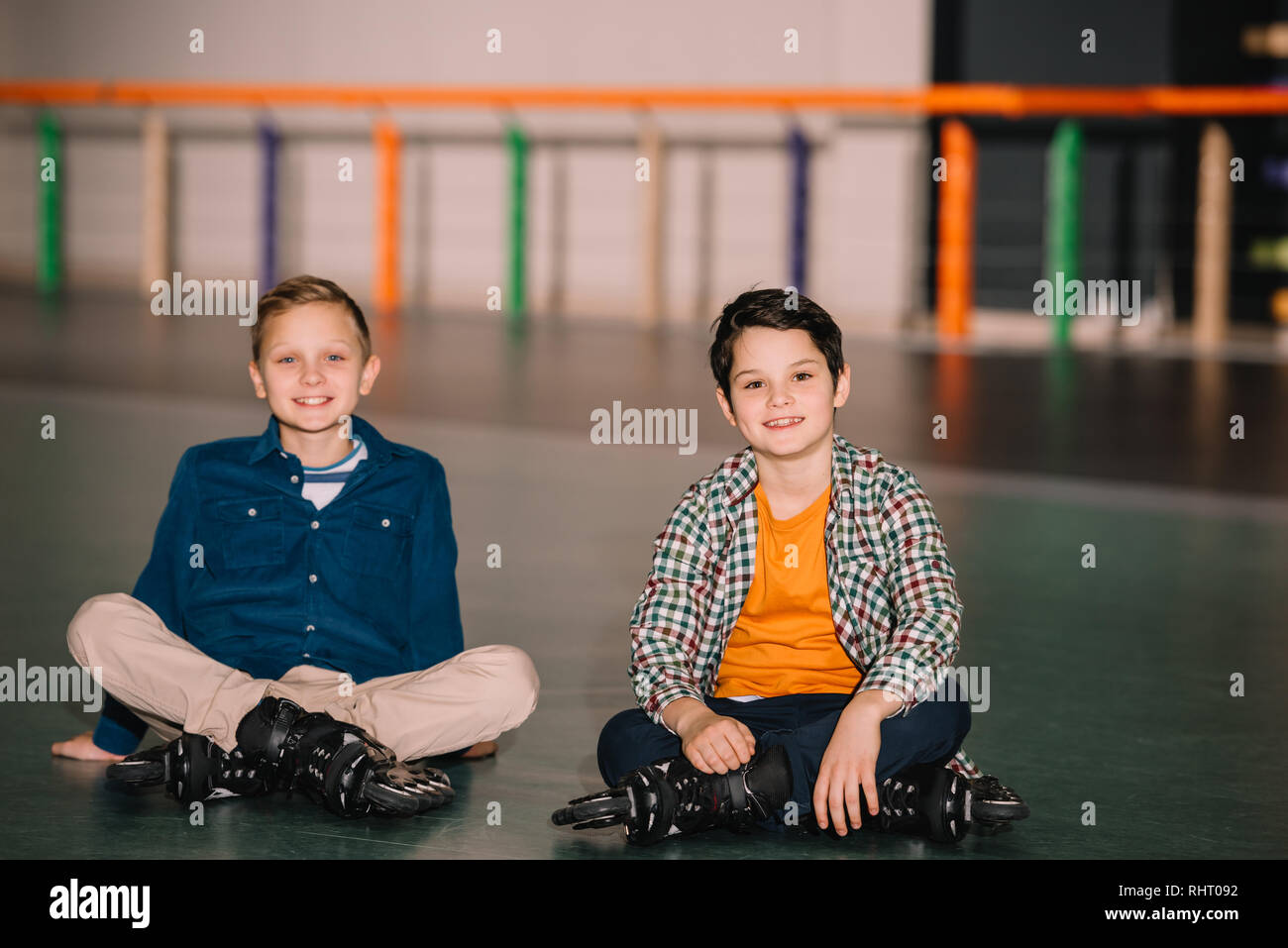 Little roller skaters looking at camera with smile Stock Photo