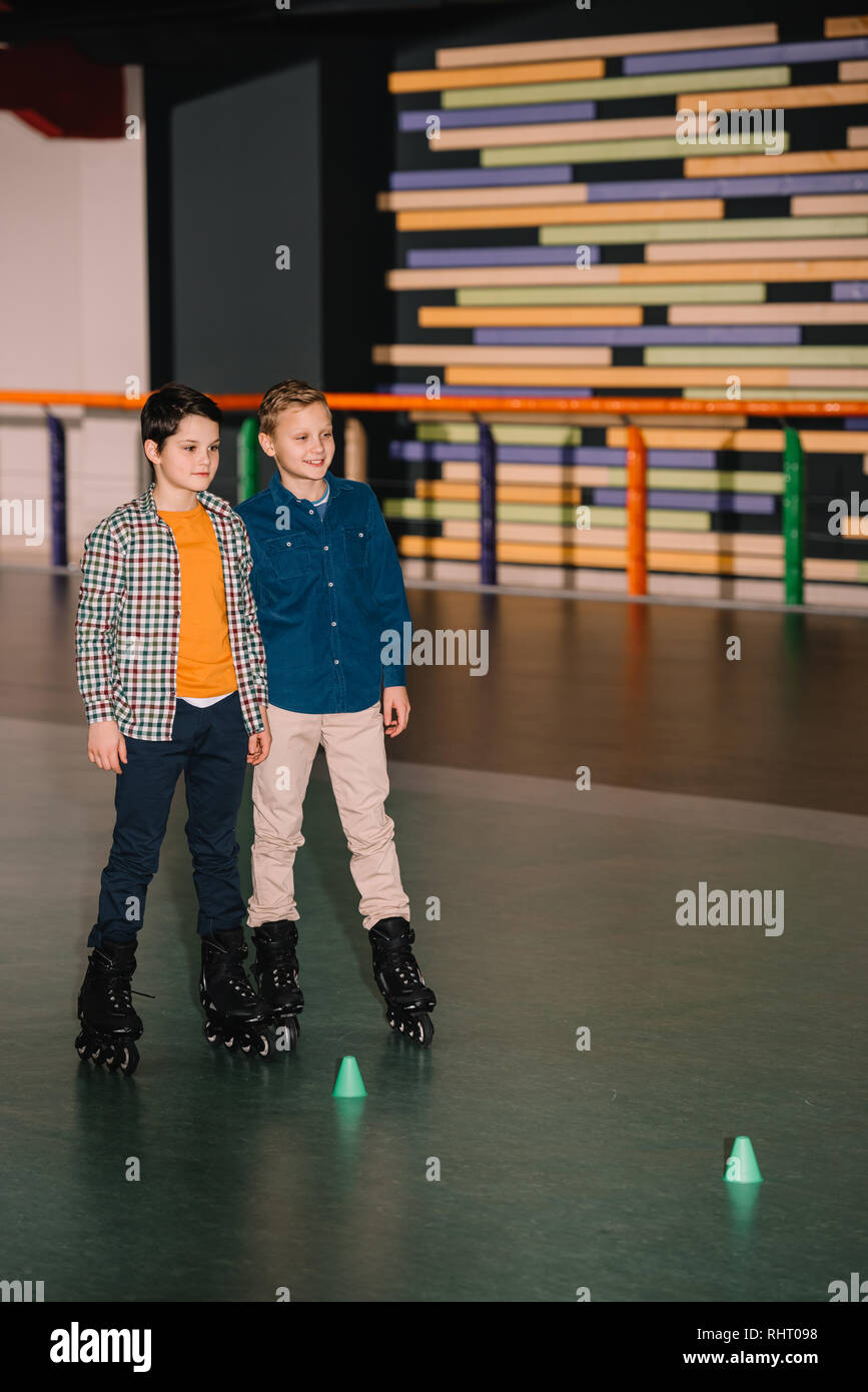 Little brothers in roller skates posing with smile Stock Photo