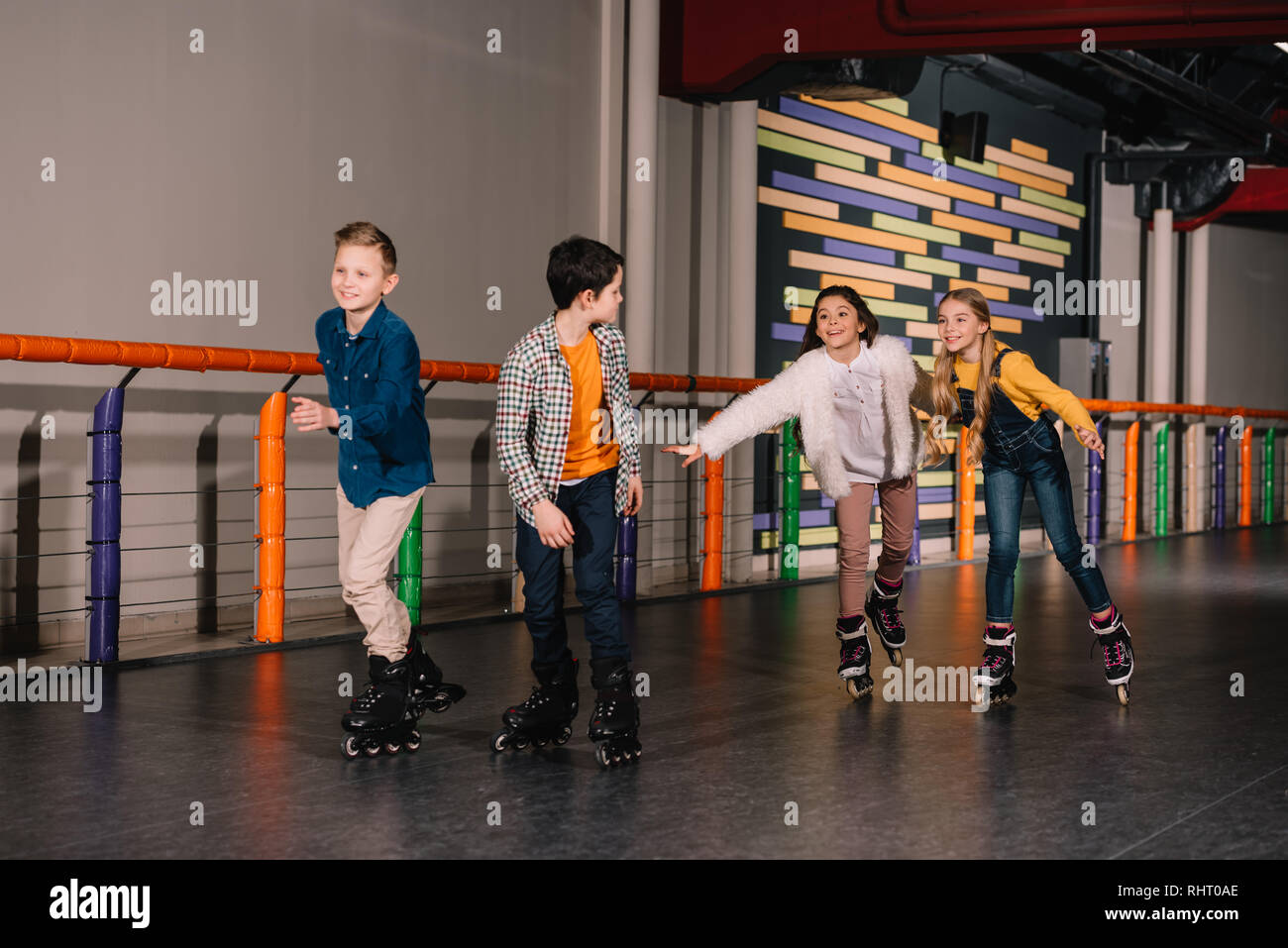 Laughing kids in roller skates enjoying leisure Stock Photo