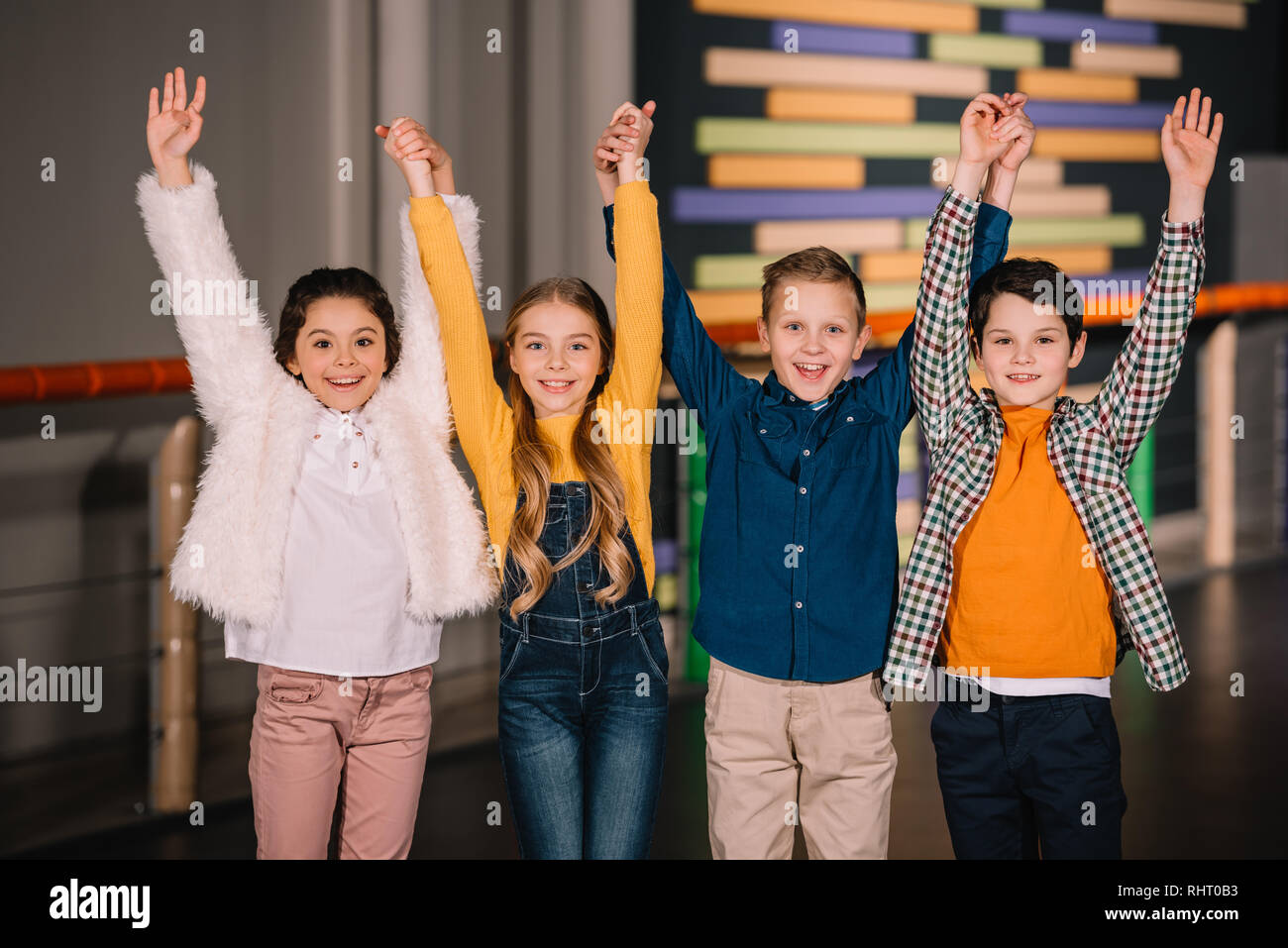 Group of kids laughing and holding hands Stock Photo