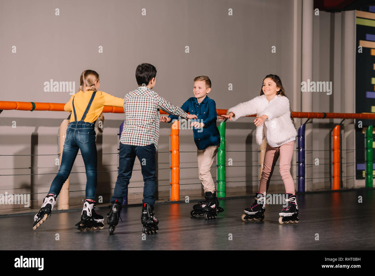 Group of kids fooling around on skater rink Stock Photo