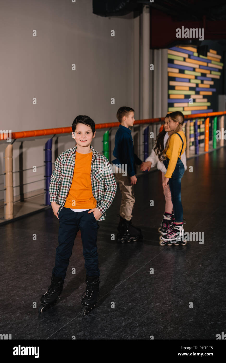 Preteen kids having fun together on roller rink Stock Photo