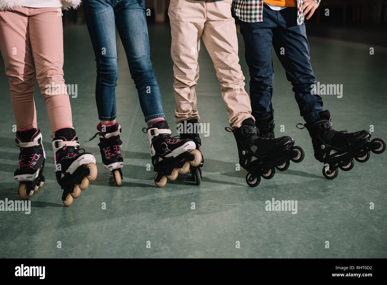 Partial view of children legs in roller skates Stock Photo