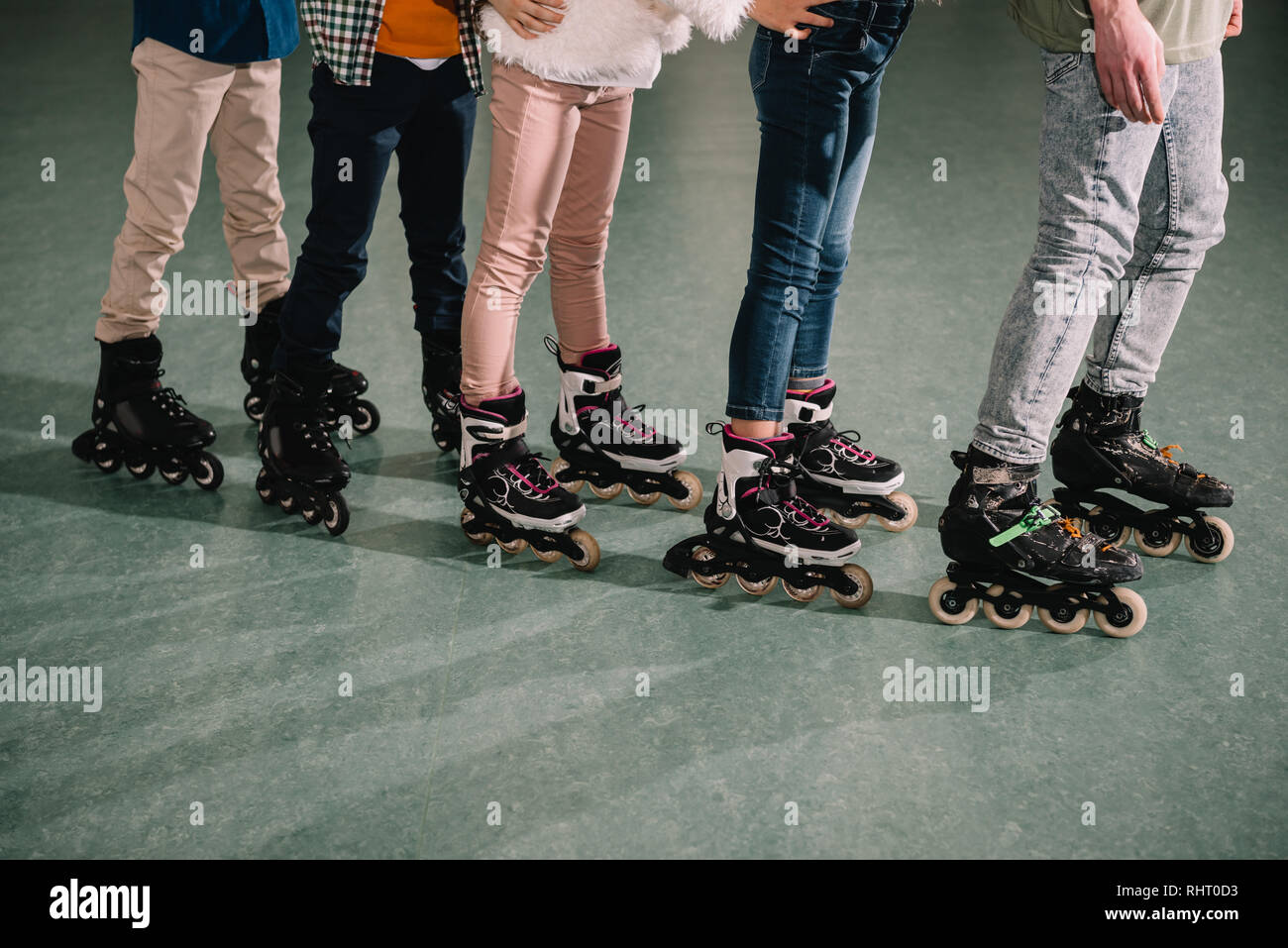 Cropped shot of several kids skating on rink Stock Photo