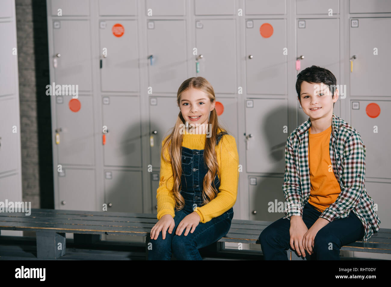 Cute kids sitting in changing room with smile Stock Photo