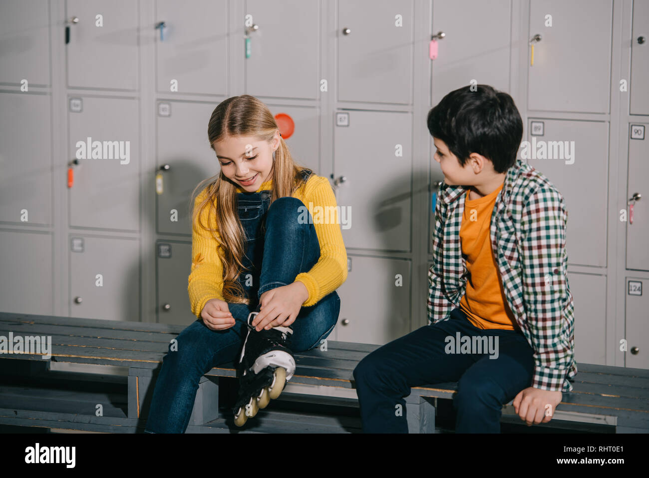 Children talking while putting on roller skates Stock Photo