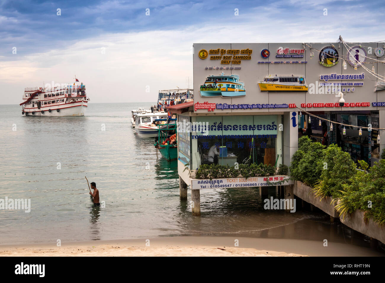 Cambodia, Preah Sihanoukh, Sihanoukhville, Occheuteal Beach, man fishing in sea at jetty Stock Photo