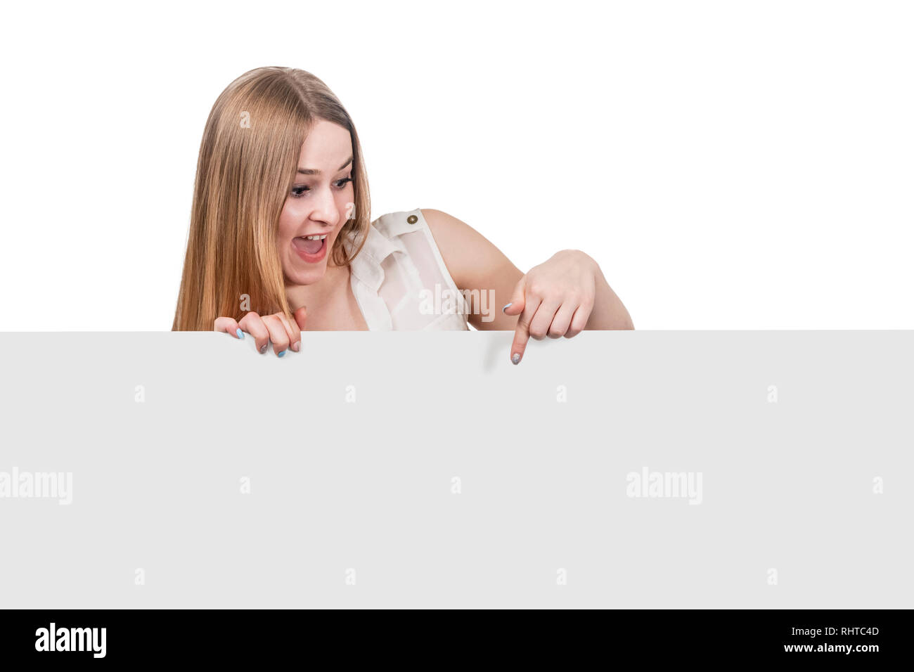 beautiful woman points finger down on a gray board for advertising isolated on white background Stock Photo