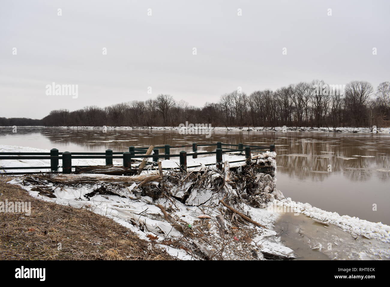 Frozen log jam against a broken boat dock on the Wabash River in Terre Haute, Indiana during a polar vortex. January 2019 Stock Photo