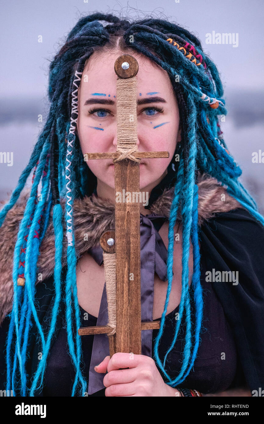 Warlike Girl With Blue Hair Dreadlocks Face Painted With