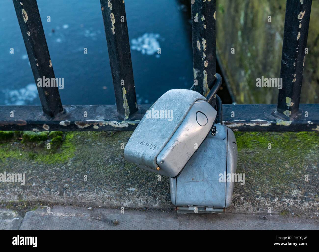 Airbnb, short term rental, keysafes locked on bridge railing, The Shore, Leith, Edinburgh, Scotland, UK Stock Photo