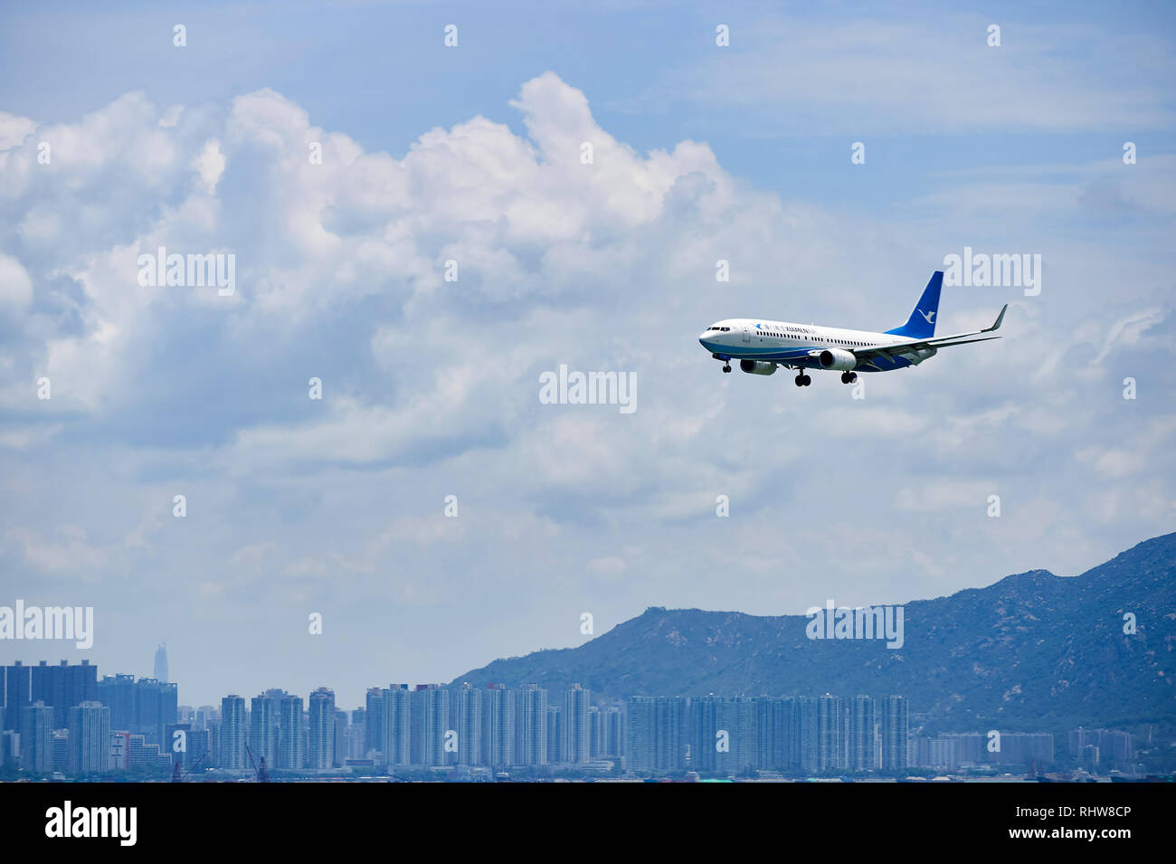 HONG KONG - JUNE 04, 2015: XiamenAir aircraft landing at Hong Kong airport. XiamenAir (formerly Xiamen Airlines) is the first privately owned airline  Stock Photo