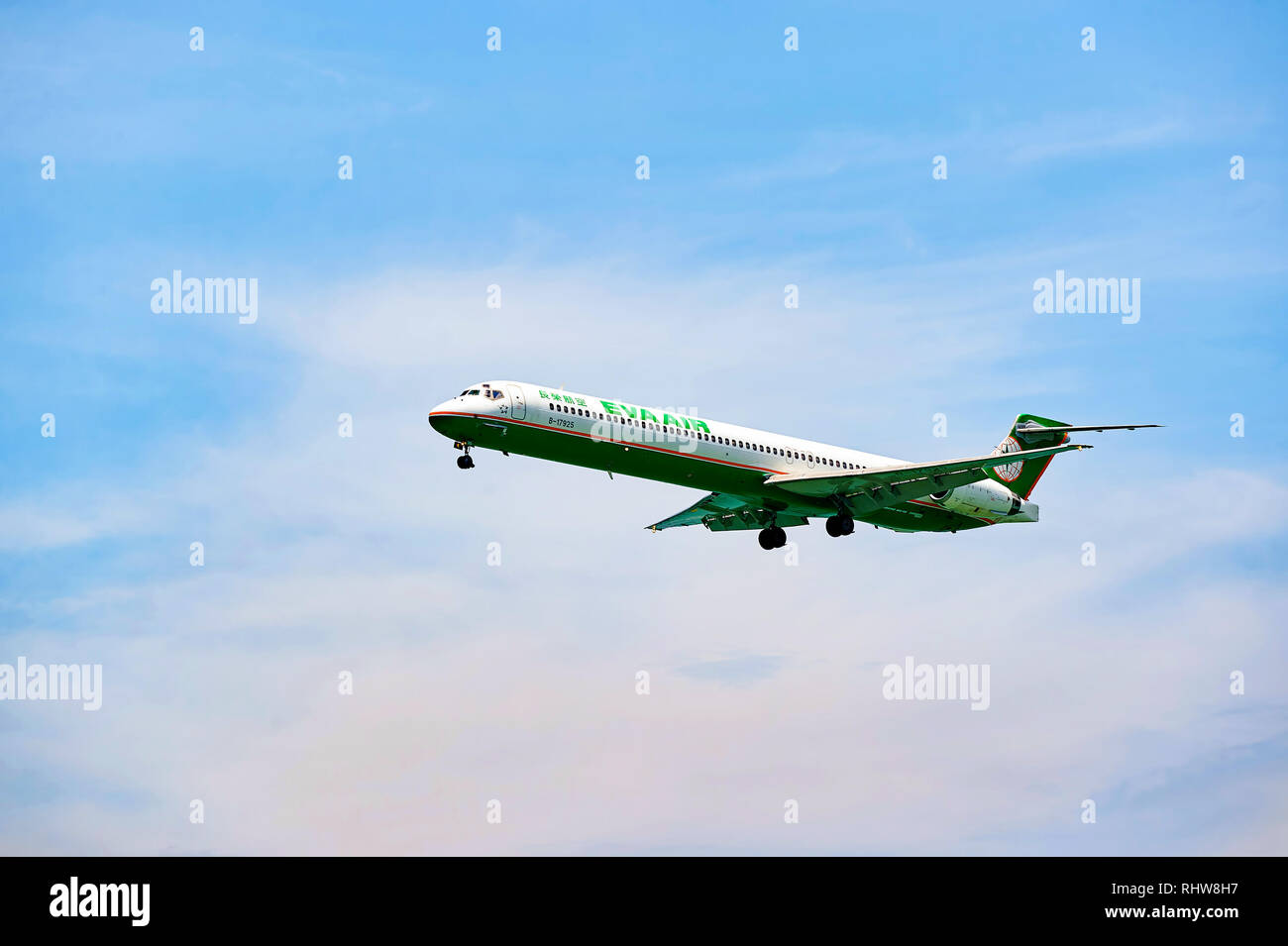 HONG KONG - JUNE 04, 2015: MD-90 landing at Hong Kong airport. The McDonnell Douglas MD-90 is a twin-engine, short- to medium-range, single-aisle comm Stock Photo