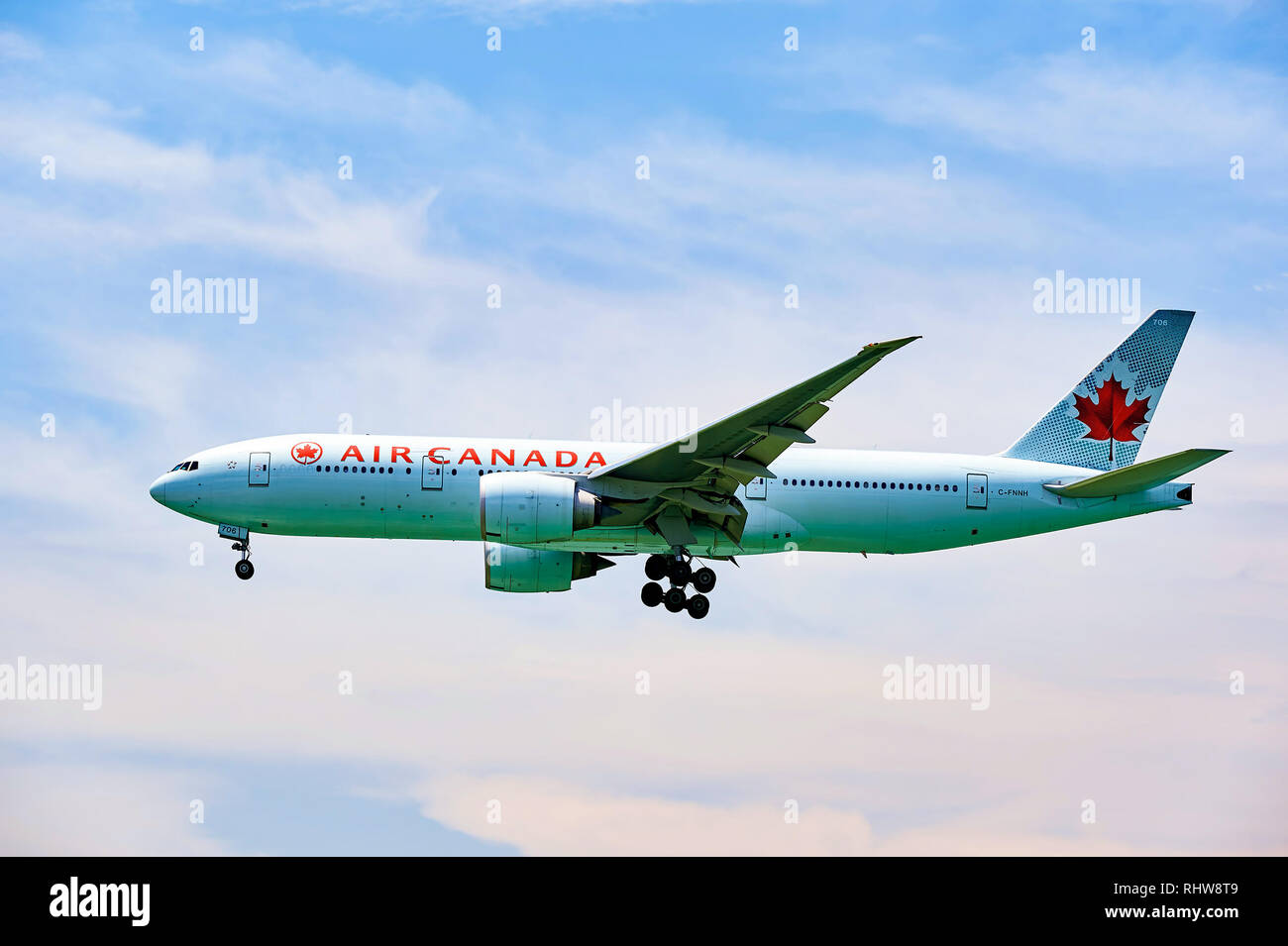 HONG KONG - JUNE 04, 2015: Air Canada Boeing 777 landing at Hong Kong airport. Air Canada is the flag carrier and largest airline of Canada. Stock Photo