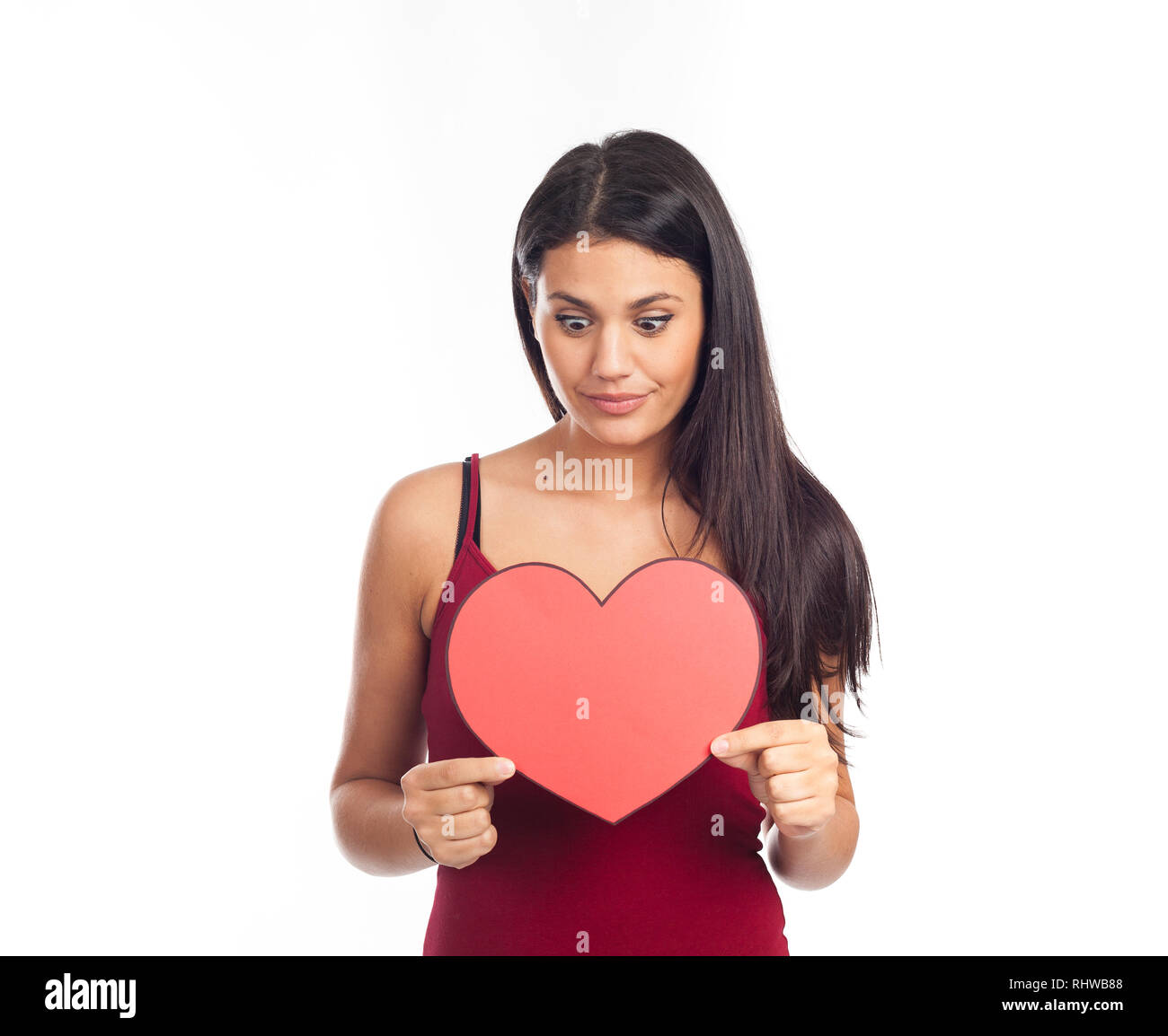 beautiful happy brunette woman holding and showing a big red heart ...