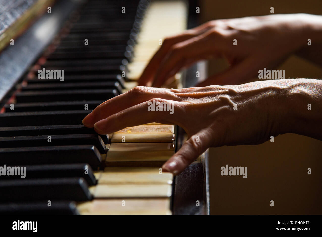 Close up fingers of woman pianist at the rusty piano keys, arms plays solo  of music. Hands of female musician playing. Music instrument, solo pian  Stock Photo - Alamy