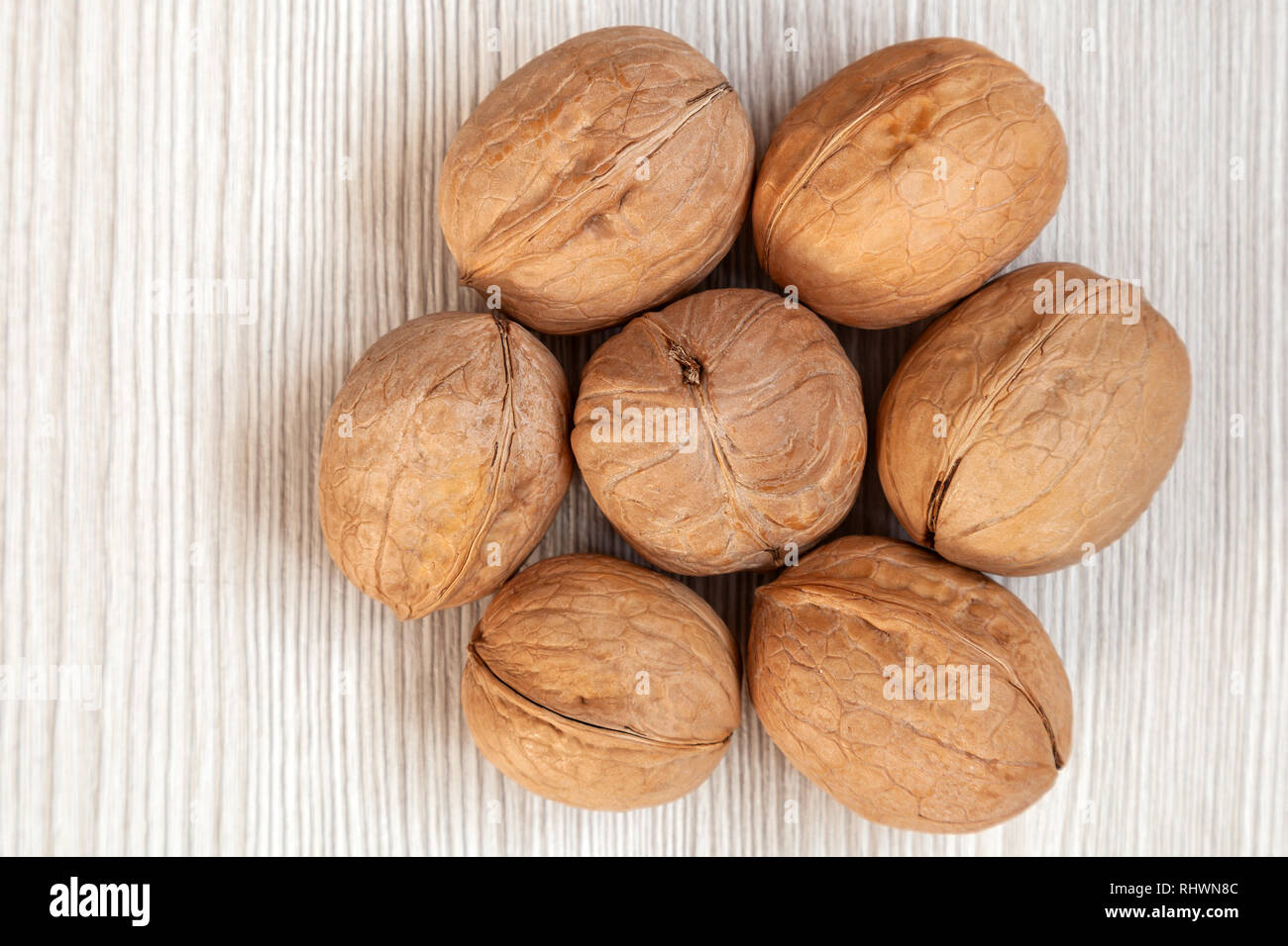 inshell walnuts on a wooden isolated background. Walnuts pattern Stock ...