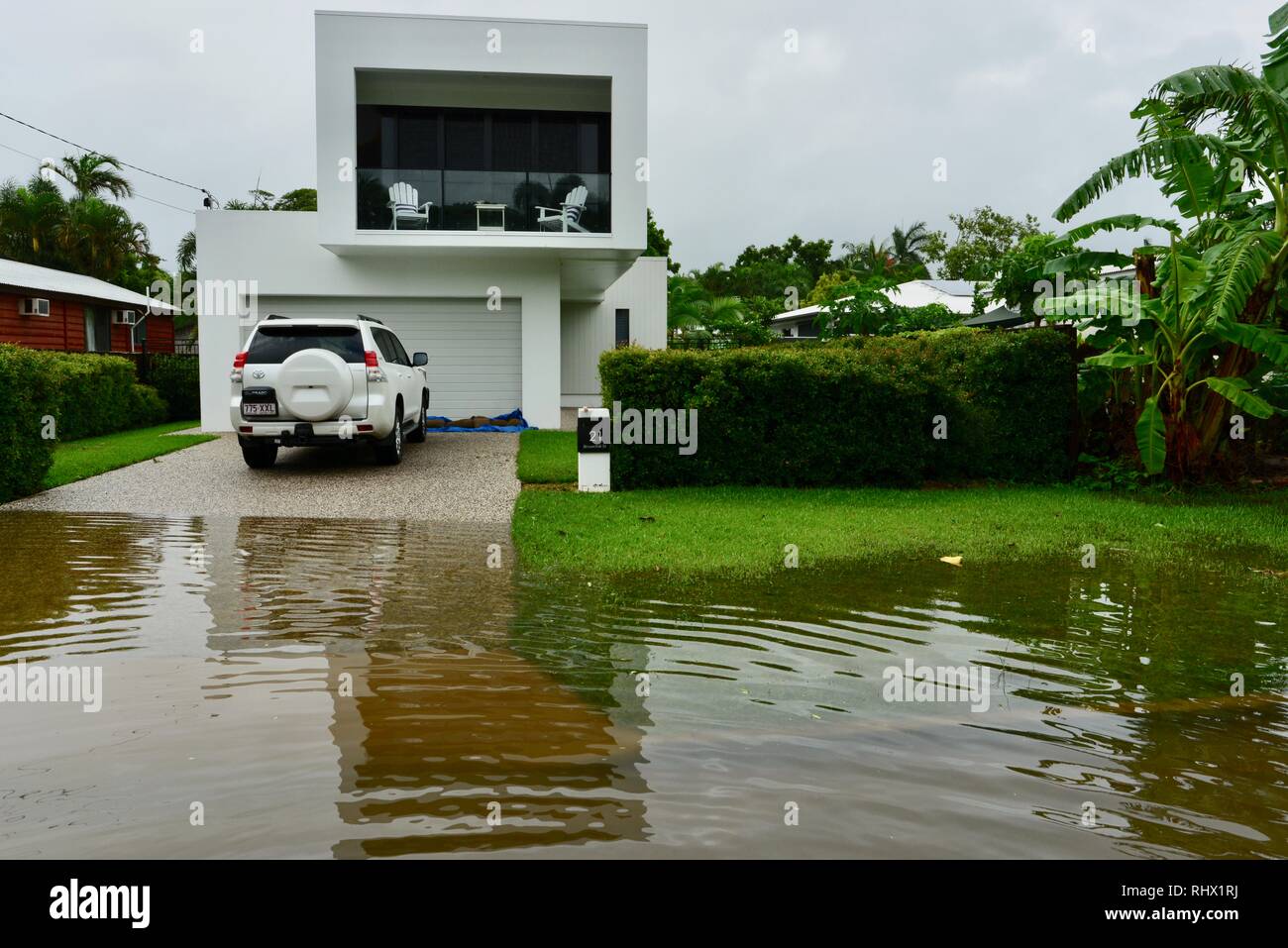 A car parked in a driveway sitting near flood waters. Townsville, Queensland, Australia. 4th Feb 2019. Flooding continued to worsen as the deluge continued and more water was released from the bulging Ross River dam to prevent the failure of the dam wall. 1000's of residents were evacuated overnight. Credit: P&F Photography/Alamy Live News Stock Photo