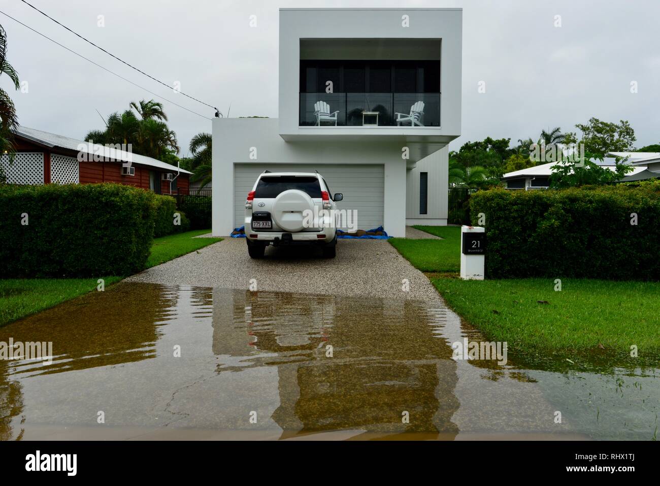 A car parked in a driveway sitting near flood waters. Townsville, Queensland, Australia. 4th Feb 2019. Flooding continued to worsen as the deluge continued and more water was released from the bulging Ross River dam to prevent the failure of the dam wall. 1000's of residents were evacuated overnight. Credit: P&F Photography/Alamy Live News Stock Photo