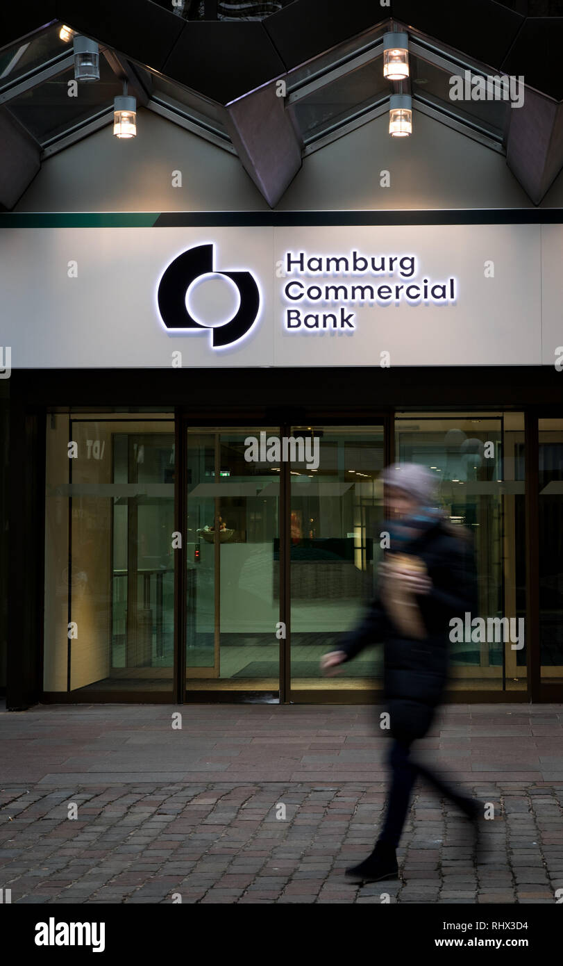 04 February 2019, Hamburg: A passer-by passes by the main entrance of the Hamburg Commercial Bank headquarters (recording with long shutter speed). Two months after the privatisation, HSH Nordbank now officially bears the new name Hamburg Commercial Bank. The change of name to a private commercial bank was formally completed with the entry in the commercial registers of Hamburg and Kiel on Monday. Photo: Christian Charisius/dpa Stock Photo