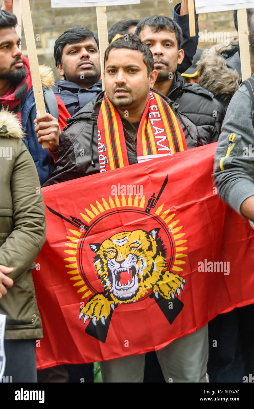 London, UK. 4th February 2019. Tamils including one with Tamil Tiger flag and Tamil scarf, protest outside the Sri Lanka High Commission, saying that his was a black day for Tamils in Sri Lanka. They demand the release of all political prisoners, an independent war crimes commission, information on the missing people and return of occupied land and call for the right to self-determination of the Tamil population. They support protesters in Sri Lanka who are protesting and fasting for the release of their land. Peter Marshall/Alamy Live News Stock Photo