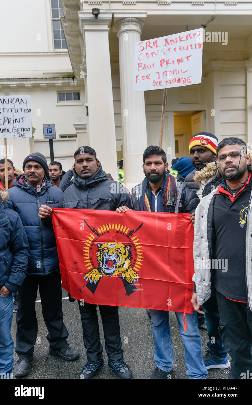 London, UK. 4th February 2019. Tamils hold a Tamil Tigerts flag at the protest outside the Sri Lanka High Commission, saying that his was a black day for Tamils in Sri Lanka. They demand the release of all political prisoners, an independent war crimes commission, information on the missing people and return of occupied land and call for the right to self-determination of the Tamil population. They support protesters in Sri Lanka who are protesting and fasting for the release of their land. Peter Marshall/Alamy Live News Stock Photo