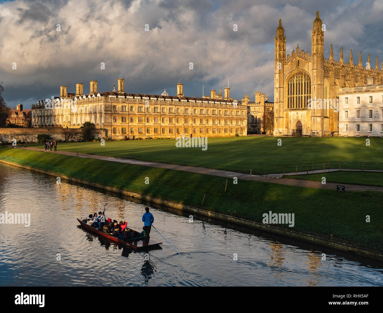 Kings College Cambridge - sunshine bursts through rainclouds and lights up medieval Kings College Chapel delighting tourists punting on the River Cam Stock Photo