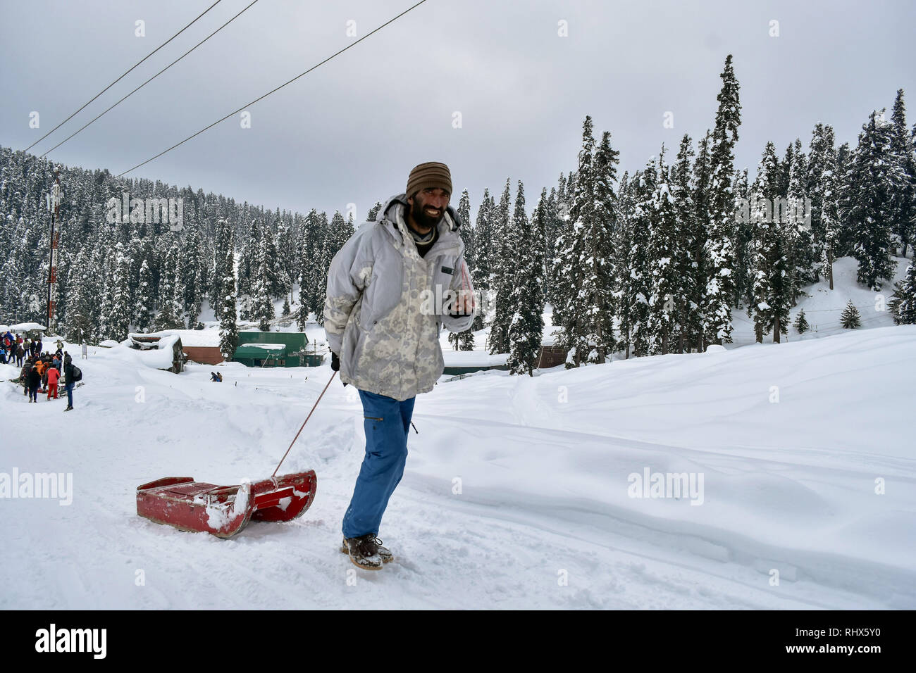 February 4, 2019 - Gulmarg, J&K, India - A Kashmiri man seen pulling his toboggan (sledge) through snow at a famous ski- resort in Gulmarg, about 55kms from Srinagar, Indian administered Kashmir.Gulmarg, situated in the foothills of the Himalayas at 2,745 meters (9,000 feet) above sea level, is one of the leading ski destinations in South Asia. Credit: Saqib Majeed/SOPA Images/ZUMA Wire/Alamy Live News Stock Photo