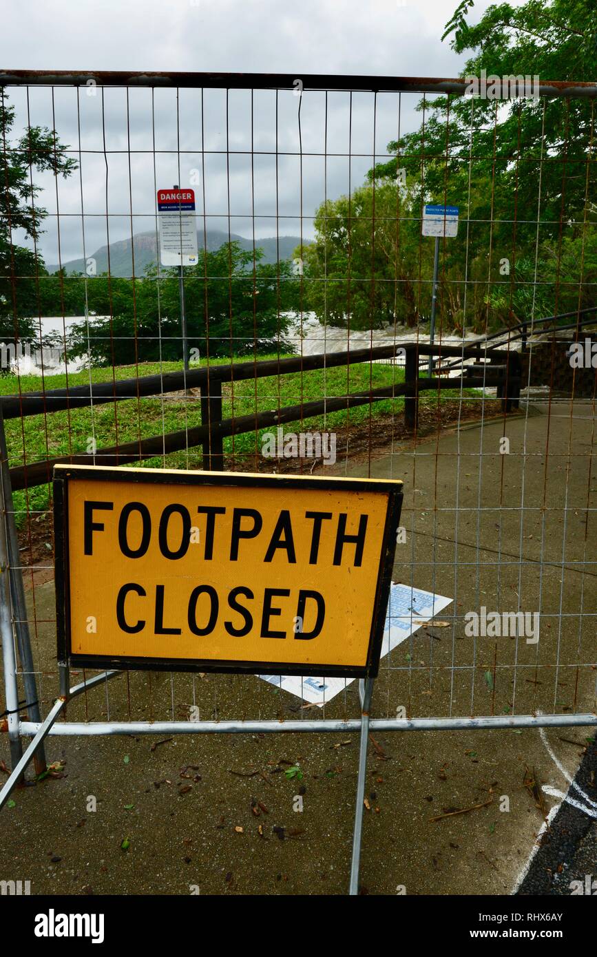 Footpath closed sign, The raging flood waters inundating Aplins weir, Townsville, Queensland, Australia. 4th February, 2019. Flooding continued to worsen as the deluge continued and more water was released from the bulging Ross River dam to prevent the failure of the dam wall. 1000's of residents were evacuated overnight. Credit: P&F Photography/Alamy Live News Stock Photo