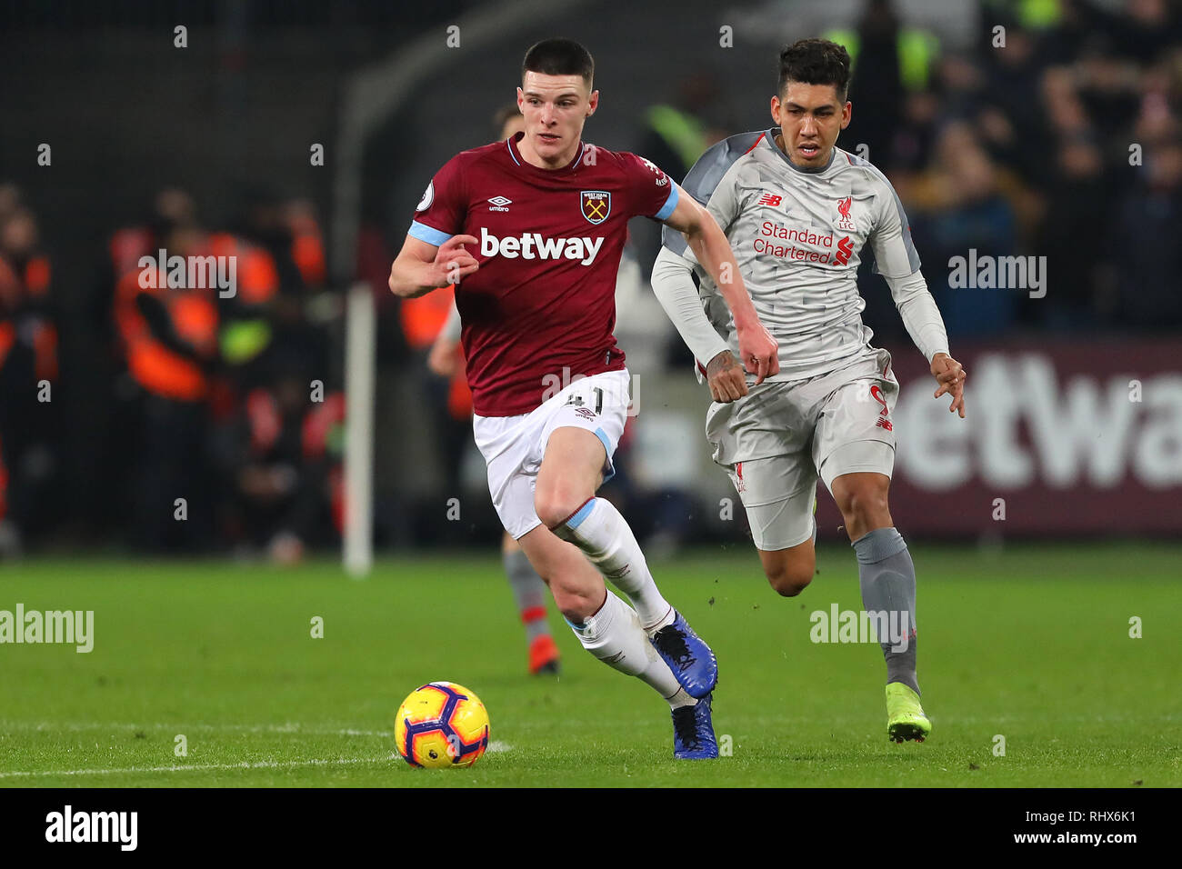 London, UK. 4th February, 2019. Declan Rice of West Ham United beats  Roberto Firmino of Liverpool - West Ham United v Liverpool, Premier League,  London Stadium, London (Stratford) - 4th February 2019