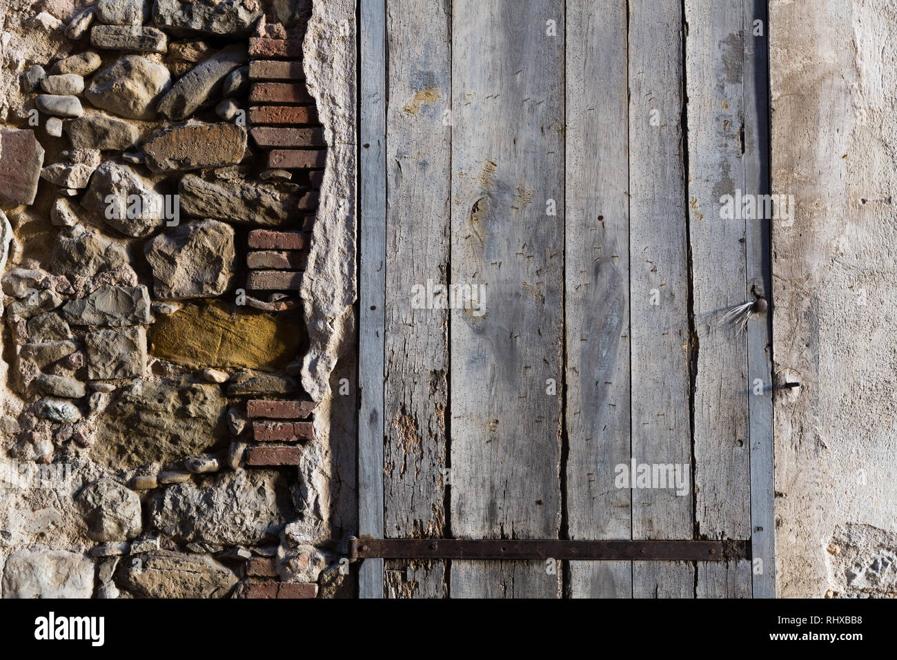 Texture of old damaged stone wall with closed wooden shutters Stock ...
