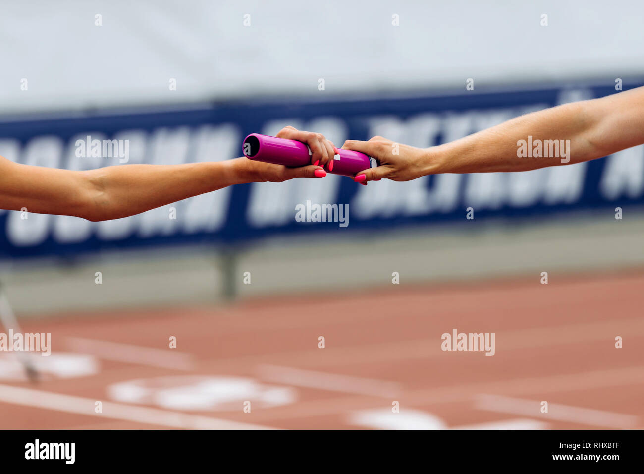 relay race racing hands women runners passing of baton Stock Photo Alamy