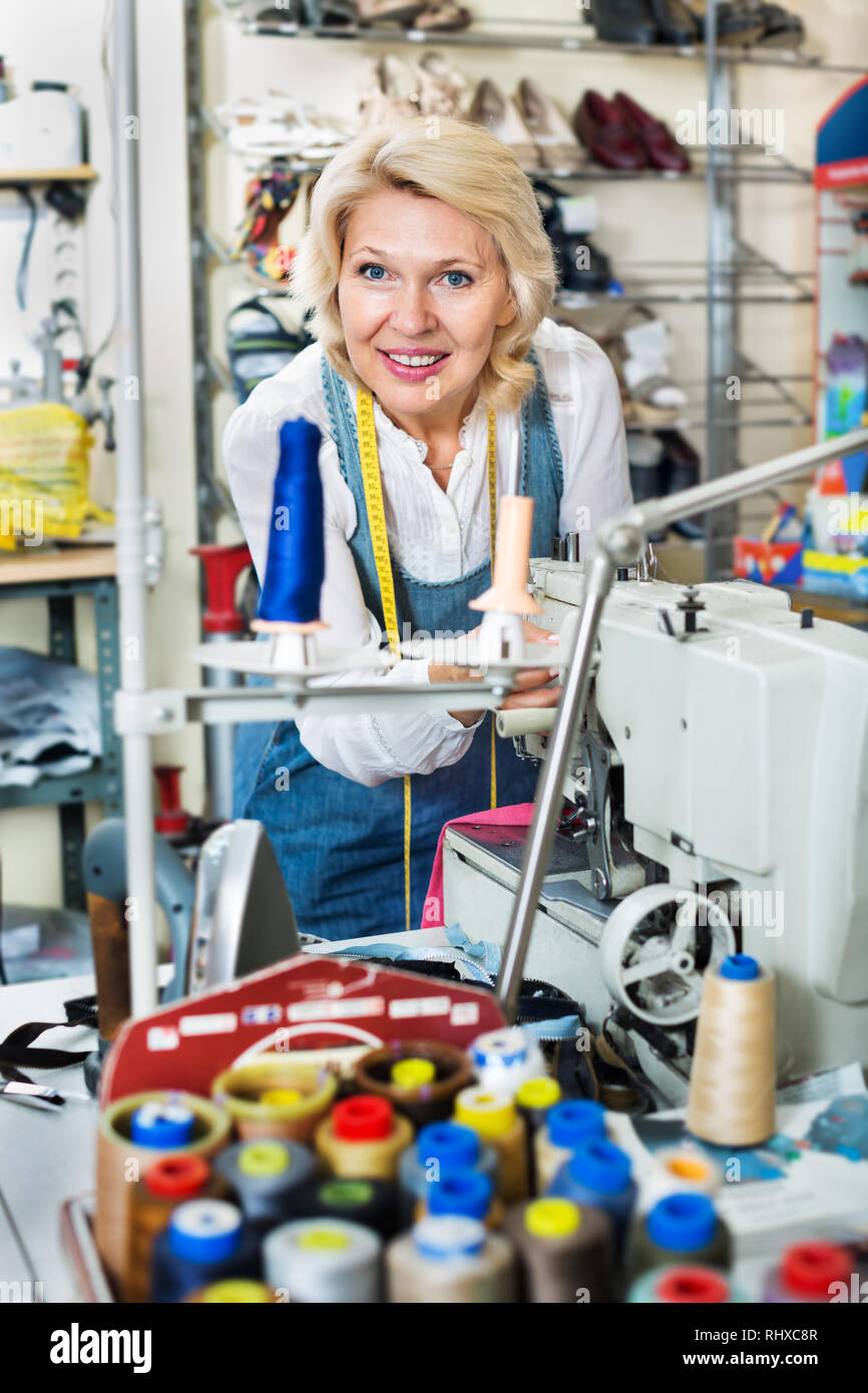 Portrait of professional female tailor working on a sewing machine at a