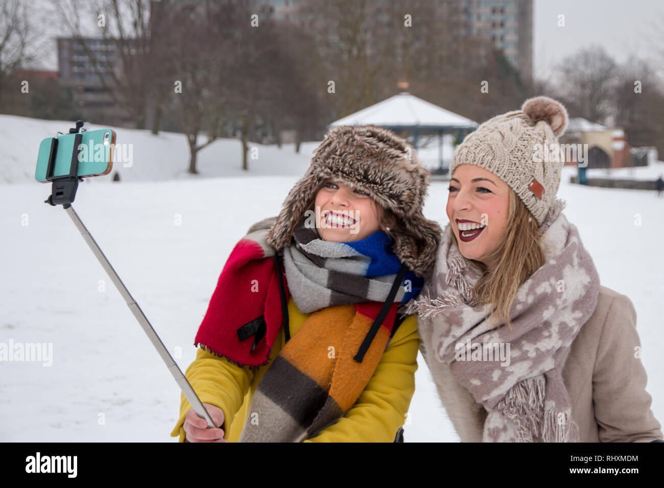 Two women taking a 'snow selfie' in Castle Park, Bristol, UK Stock Photo
