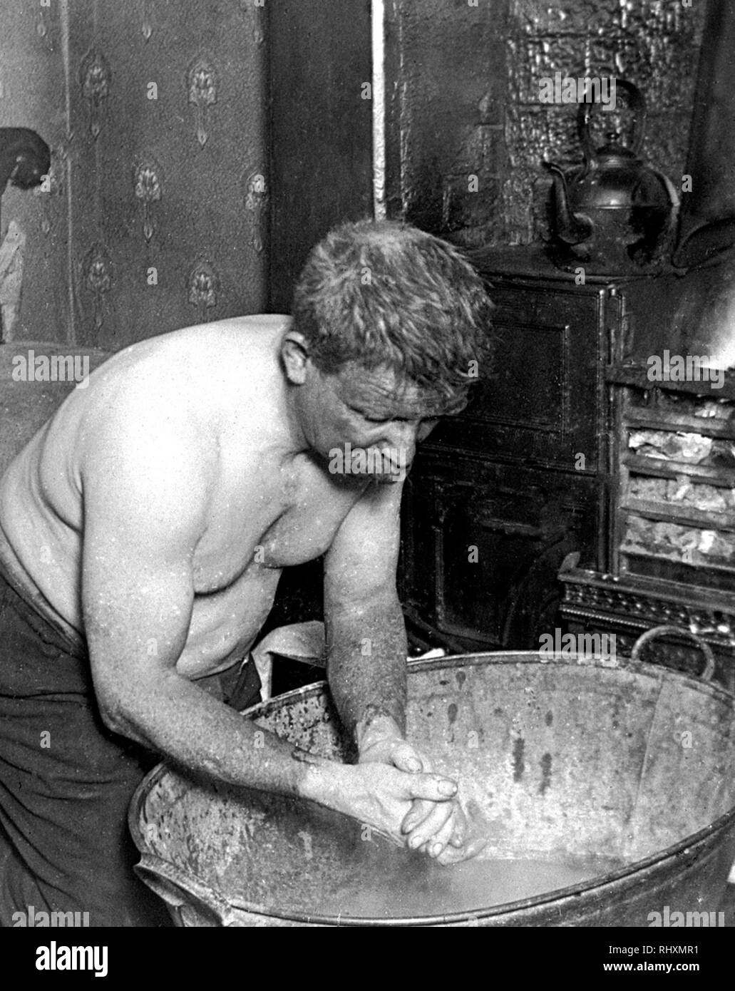 Coal miner washing at home Stock Photo
