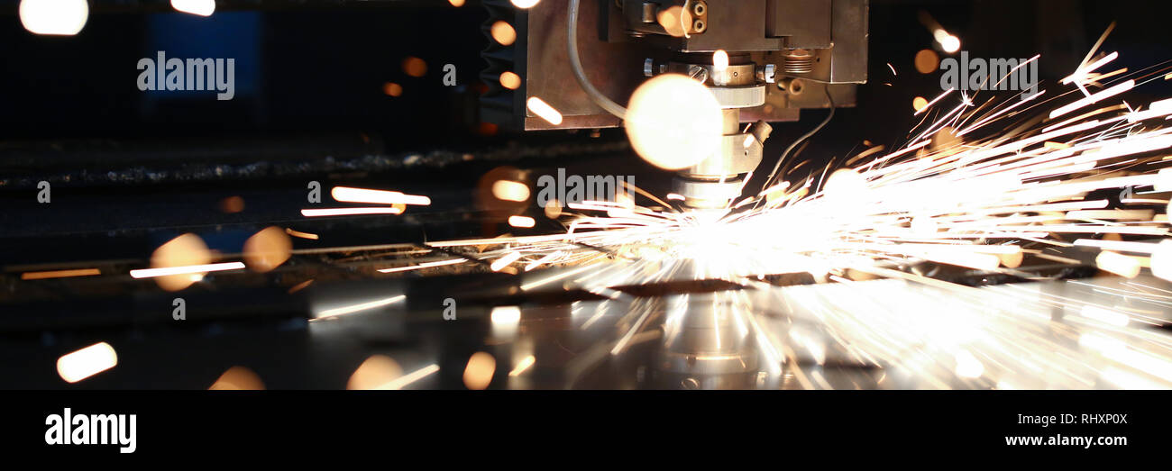 Sparks fly out machine head for metal processing Stock Photo