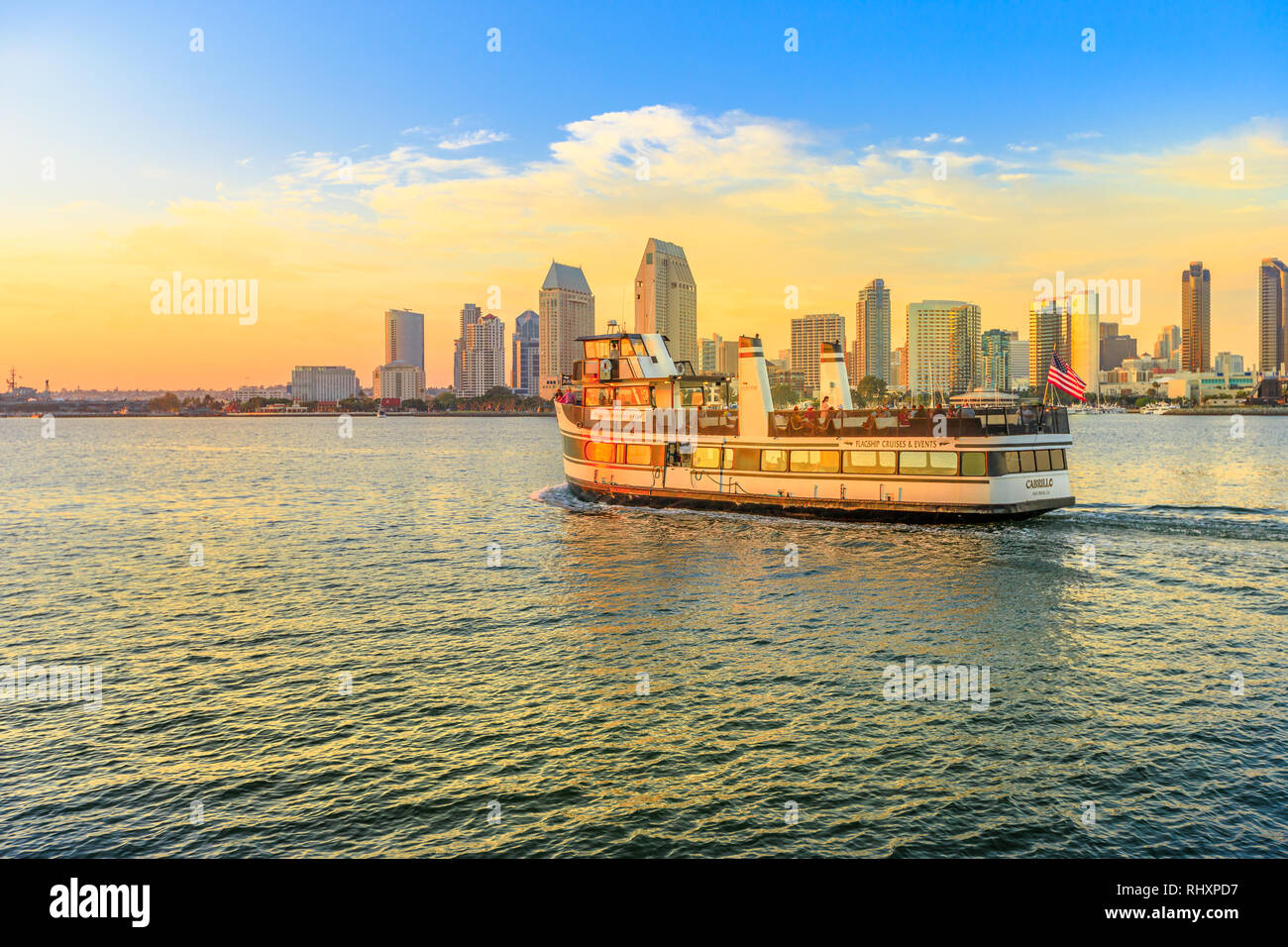 San Diego, California, United States - August 1, 2018: ferry cruise goes into waters of San Diego Bay with San Diego skyline waterfront marina and Stock Photo