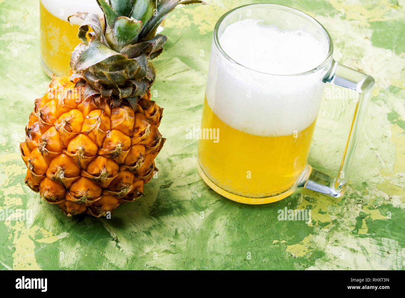 Glass with eya with pineapple flavor. Pineapple alcoholic ale Stock