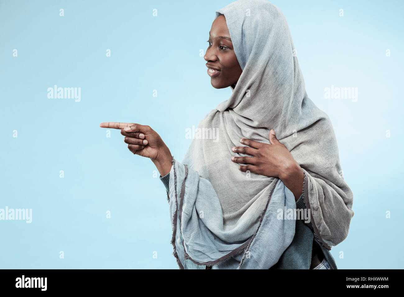 The beautiful young black african muslim girl wearing gray hijab 