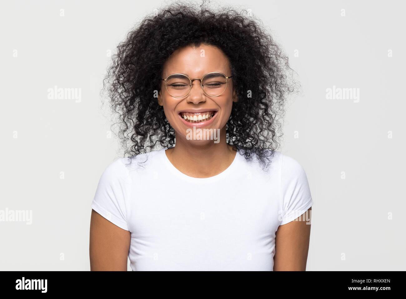 Funny african woman laughing isolated on white grey studio background Stock Photo