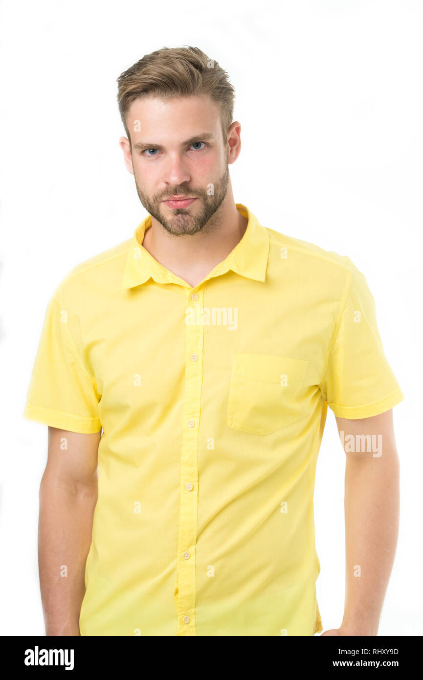 Man on calm face posing confidently in cotton shirt, white background.  Fashion concept. Man looks attractive in casual yellow linen shirt. Guy  with bristle wears casual or formal wear Stock Photo -