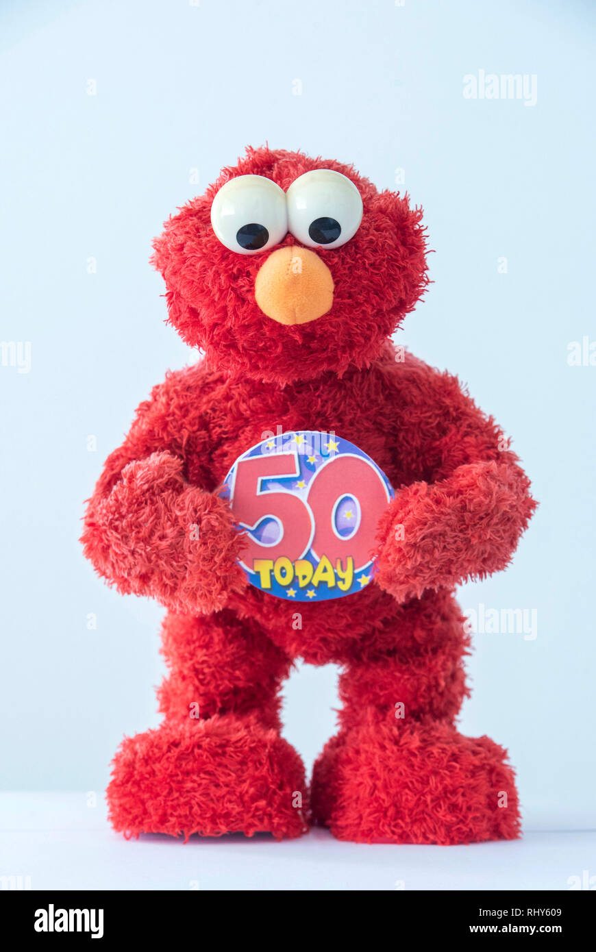 A toy of Elmo, the Muppet character on Sesame Street holding a 50th