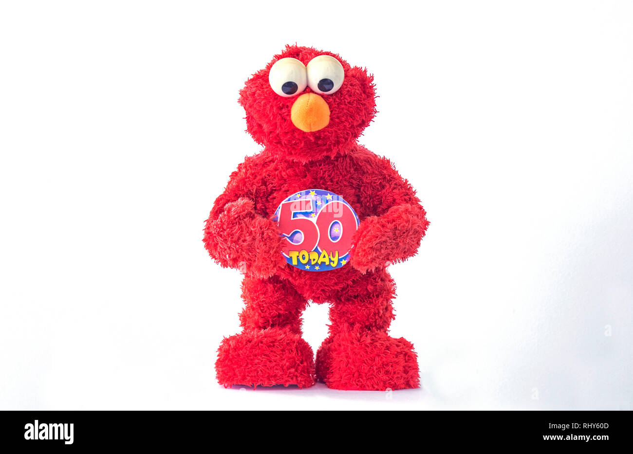 A toy of Elmo, the Muppet character on Sesame Street holding a 50th birthday badge. The children's television show is fifty years old in 2019. Stock Photo