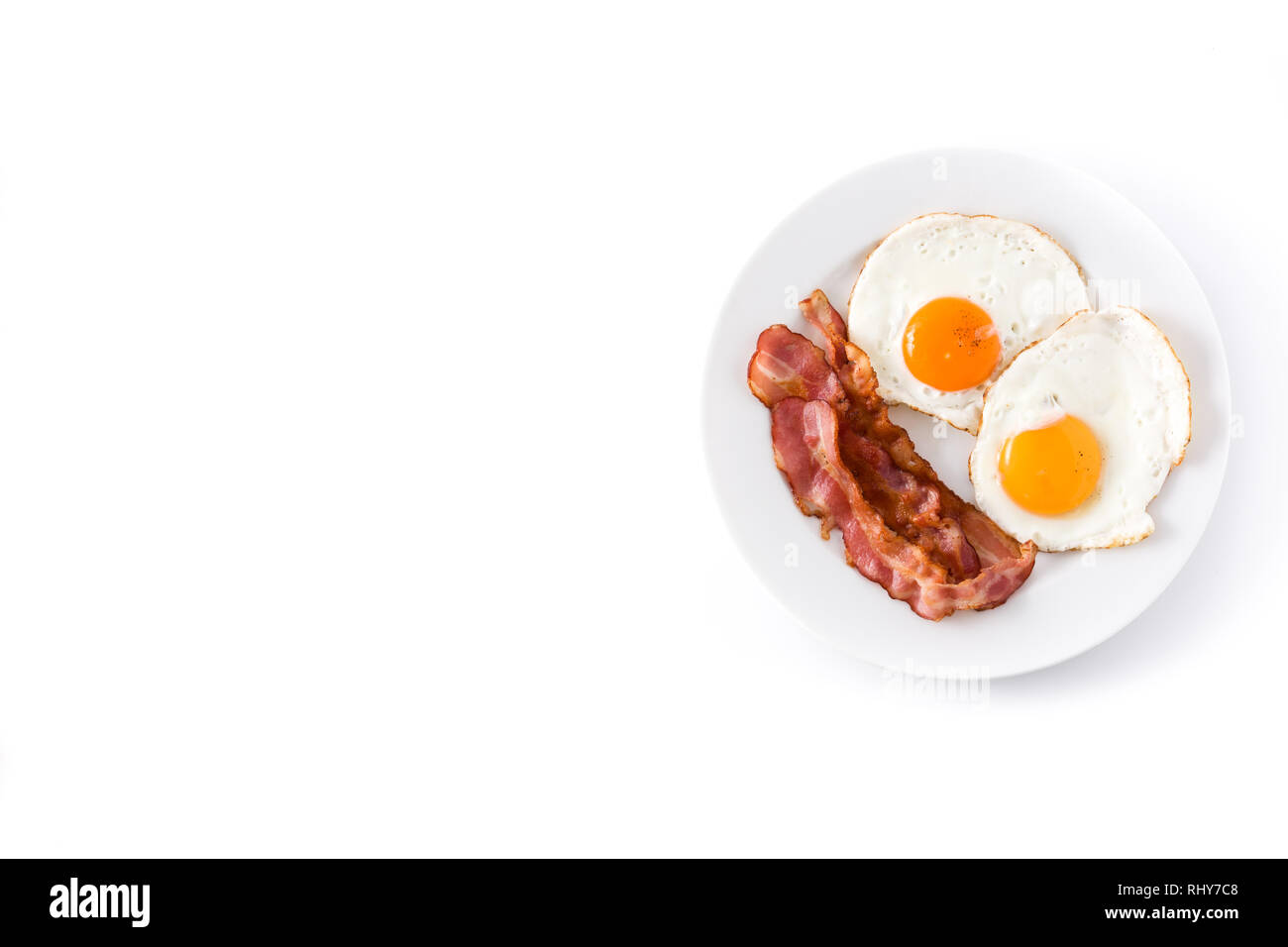 Fried eggs and bacon for breakfast isolated on white background.Top ...