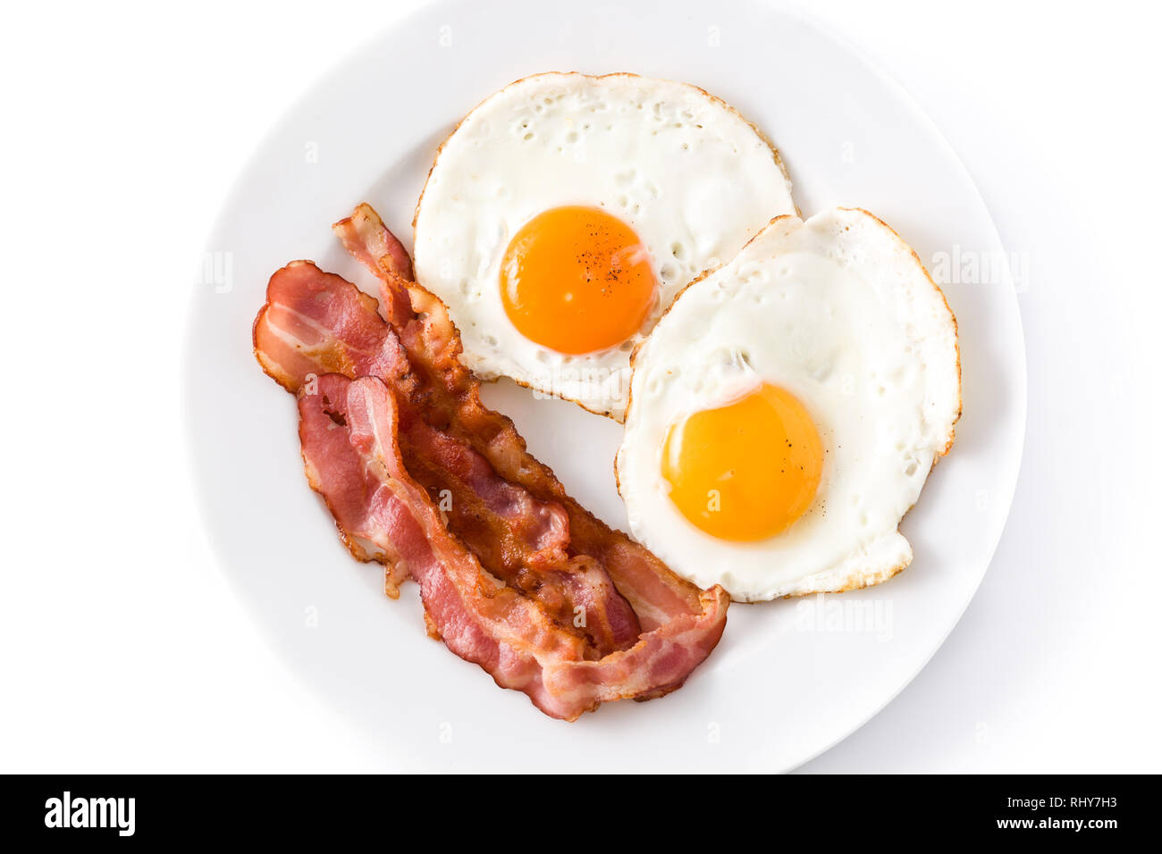 Fried eggs and bacon for breakfast isolated on white background.Top ...