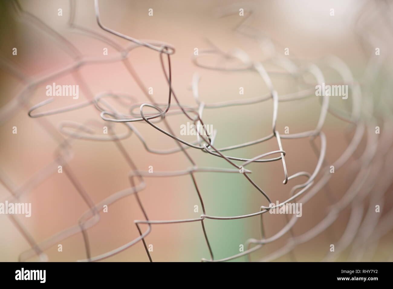 Torn barbed wire bent. Damaged fence Stock Photo